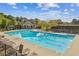 Inviting community pool with lounge chairs and a beautiful clubhouse, perfect for summer relaxation and fun at 2109 Cape Ivey Ct, Dacula, GA 30019