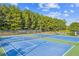 Community tennis courts surrounded by mature trees provide a scenic and active recreational space at 2109 Cape Ivey Ct, Dacula, GA 30019