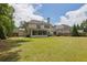 A well-maintained backyard with a sunroom, a lush lawn, and mature landscaping at 2205 Beaver Shop Ne Rd, Marietta, GA 30066