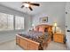 Bedroom features a ceiling fan, window with shutter, and a bed with two nightstands at 2205 Beaver Shop Ne Rd, Marietta, GA 30066