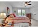 Bedroom features a ceiling fan, bright window, and a comfortable bed with decorative pillows at 2205 Beaver Shop Ne Rd, Marietta, GA 30066