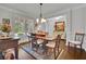 Dining room with hardwood floors, wainscoting and large windows bringing in natural light at 2205 Beaver Shop Ne Rd, Marietta, GA 30066