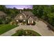 A traditionally styled home with large driveway, manicured lawn, and mature trees at 2205 Beaver Shop Ne Rd, Marietta, GA 30066