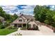 Beautiful home featuring a manicured lawn, complementary shrubbery, and a concrete driveway at 2205 Beaver Shop Ne Rd, Marietta, GA 30066