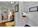 Hallway with hardwood floors leading to a laundry room and a nook with white cabinets at 2205 Beaver Shop Ne Rd, Marietta, GA 30066