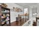 Upstairs hallway with hardwood floors and bookshelf leading to bedroom at 2205 Beaver Shop Ne Rd, Marietta, GA 30066