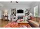 Elegant living room featuring a fireplace, hardwood floors, and built-in shelves at 2205 Beaver Shop Ne Rd, Marietta, GA 30066