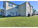 The backyard has a spacious lawn with an air conditioning unit near the building at 2326 Nicole Dr, Hampton, GA 30228