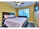 Bedroom featuring a ceiling fan, hardwood floors, and a window with natural light at 2326 Nicole Dr, Hampton, GA 30228