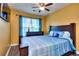 Bedroom featuring a window, hardwood floors, and a ceiling fan at 2326 Nicole Dr, Hampton, GA 30228