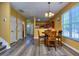 Bright dining area next to the kitchen with natural lighting and wood-look floors at 2326 Nicole Dr, Hampton, GA 30228