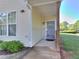 Inviting entrance with covered porch, a secure screen door and well-kept landscaping at 2326 Nicole Dr, Hampton, GA 30228