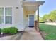 Inviting entrance with covered porch, a secure screen door and well-kept landscaping at 2326 Nicole Dr, Hampton, GA 30228