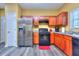 Functional kitchen with stainless steel refrigerator, dark cabinetry, and plenty of counter space at 2326 Nicole Dr, Hampton, GA 30228