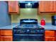 Close up of kitchen cook top, with dark cabinets and an exhaust fan at 2326 Nicole Dr, Hampton, GA 30228