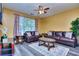 Cozy living room with leather seating, ceiling fan, and neutral decor at 2326 Nicole Dr, Hampton, GA 30228