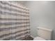 Neutral colored shower curtain and toilet at 430 Pilgrim Ln, Powder Springs, GA 30127
