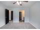 Neutral bedroom with gray carpet and a ceiling fan with doors leading to the bathroom and closet at 430 Pilgrim Ln, Powder Springs, GA 30127
