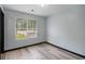 This bedroom features a window and wood-look flooring, offering a comfortable space at 430 Pilgrim Ln, Powder Springs, GA 30127