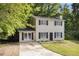 Charming two-story home with black shutters and a welcoming front yard surrounded by lush trees at 430 Pilgrim Ln, Powder Springs, GA 30127