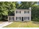 Charming two-story home with black shutters and a welcoming front yard surrounded by lush trees at 430 Pilgrim Ln, Powder Springs, GA 30127