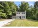 Charming two-story home with black shutters and a welcoming front yard surrounded by lush trees at 430 Pilgrim Ln, Powder Springs, GA 30127