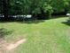 Lush backyard featuring a well-maintained lawn and shade trees at 5517 Rock Shoals Way, Atlanta, GA 30349