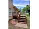 A backyard deck featuring access stairs and brick pavers that lead to the lush green yard at 5517 Rock Shoals Way, Atlanta, GA 30349