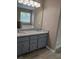 Bathroom vanity with granite countertops and a large mirror and wood look flooring at 5517 Rock Shoals Way, Atlanta, GA 30349