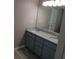 Bathroom featuring double granite vanity and updated flooring at 5517 Rock Shoals Way, Atlanta, GA 30349