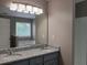 Bathroom featuring double vanity, granite countertops, and a large mirror and lighting fixture at 5517 Rock Shoals Way, Atlanta, GA 30349