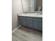 Bathroom featuring double granite vanity and updated flooring at 5517 Rock Shoals Way, Atlanta, GA 30349