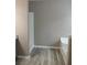 Bathroom featuring a large white tub and updated flooring at 5517 Rock Shoals Way, Atlanta, GA 30349
