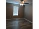 Bedroom with ceiling fan, wood-look floors, neutral walls, and natural light from a window at 5517 Rock Shoals Way, Atlanta, GA 30349