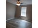 Neutral bedroom with updated flooring, ceiling fan, and window at 5517 Rock Shoals Way, Atlanta, GA 30349