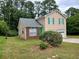 Well-maintained two-story home with green shutters, and a brick accent wall, surrounded by lush greenery at 5517 Rock Shoals Way, Atlanta, GA 30349