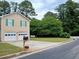 Two-story home featuring a two-car garage, well-kept lawn, and traditional architectural design at 5517 Rock Shoals Way, Atlanta, GA 30349