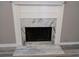 Close up on fireplace with white mantle and marble surround at 5517 Rock Shoals Way, Atlanta, GA 30349