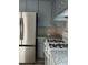 Well-lit kitchen with stainless steel refrigerator and granite countertops at 5517 Rock Shoals Way, Atlanta, GA 30349