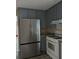 The kitchen is equipped with a stainless steel refrigerator and gas range, complemented by ample gray cabinet space at 5517 Rock Shoals Way, Atlanta, GA 30349