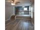 Open living room view with wood-look floors, stairs, and an open railing to the kitchen at 5517 Rock Shoals Way, Atlanta, GA 30349