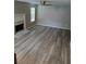 The living room features wood-look floors, a modern ceiling fan, and a cozy fireplace at 5517 Rock Shoals Way, Atlanta, GA 30349