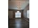 Well lit open room featuring vinyl flooring, a chandelier, and natural light at 5517 Rock Shoals Way, Atlanta, GA 30349
