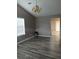 Bright living room features new floors, vaulted ceilings, and classic gold chandelier at 5517 Rock Shoals Way, Atlanta, GA 30349