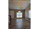 Bright living room with stylish gray wood floors, vaulted ceiling, and a charming chandelier at 5517 Rock Shoals Way, Atlanta, GA 30349