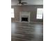 Spacious living room has a classic fireplace, ceiling fan, and lovely wood-look floors at 5517 Rock Shoals Way, Atlanta, GA 30349