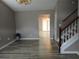 Bright living room with gray walls, light wood floors, and staircase at 5517 Rock Shoals Way, Atlanta, GA 30349