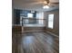 Open concept living room with stairs, connecting to the kitchen and featuring beautiful wood-look floors at 5517 Rock Shoals Way, Atlanta, GA 30349