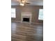 Inviting living room features a classic fireplace, ceiling fan, and lovely wood-look floors at 5517 Rock Shoals Way, Atlanta, GA 30349
