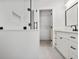 Sleek white bathroom featuring a glass-enclosed shower, modern vanity, and walk-in closet at 73 Whitefoord Se Ave, Atlanta, GA 30317